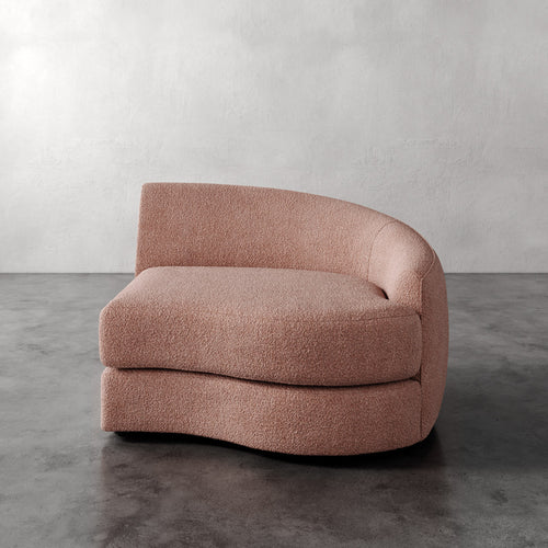 Lemieux Et Cie Rulmann Right Arm Chair Pink curved sofa against a plain wall