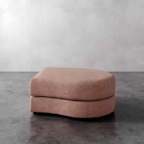 Lemieux Et Cie Rulmann Right Ottoman Pink ottoman on a gray floor with a white wall background