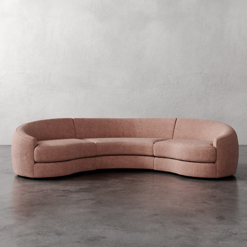 Lemieux Et Cie Rulmann Rulmann 3-Piece Sectional Curved pink sofa against a plain wall