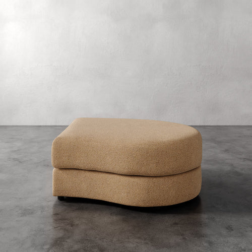 Lemieux Et Cie Rulmann Right Ottoman Beige ottoman on a gray floor with a white wall background