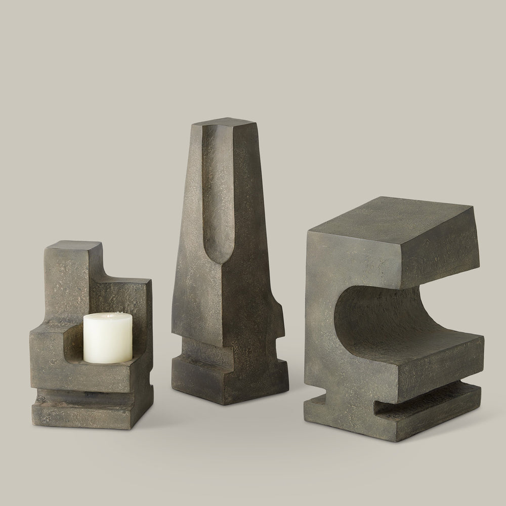 Lemieux et Cie La Structure Sculptures in grey stone, geometric sculptural candleholder set with carved recesses, shown on neutral studio backdrop.