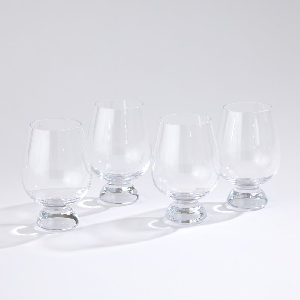 Lemieux et Cie Meriel drinking glasses with semi-spherical bases, set of four shown on white studio backdrop with soft shadows.