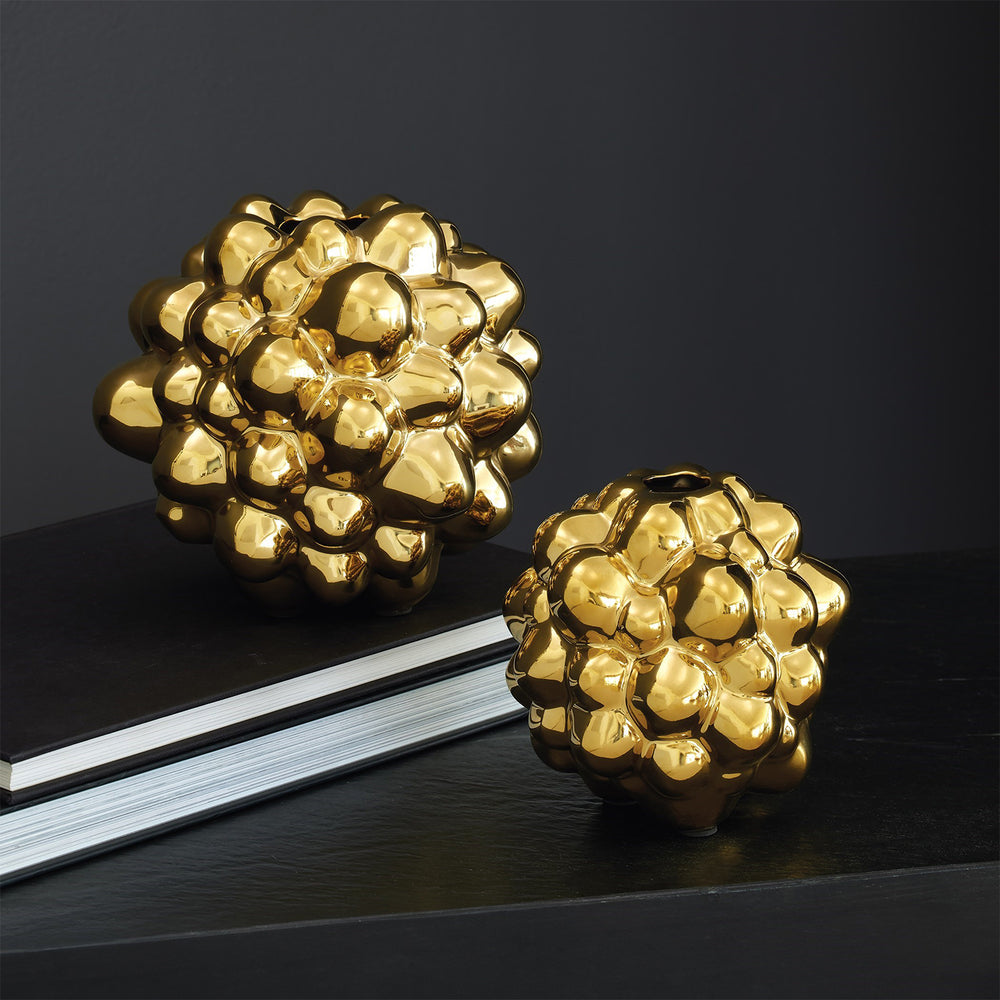 Lemieux et Cie Bubble Vase in electroplated gold finish, sculptural clustered form in two sizes, styled on dark tabletop with book.