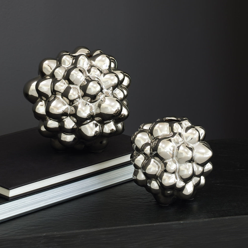 Lemieux et Cie Bubble Vase in electroplated silver finish, sculptural ceramic vessel with organic clustered form, styled on dark wood surface with book.
