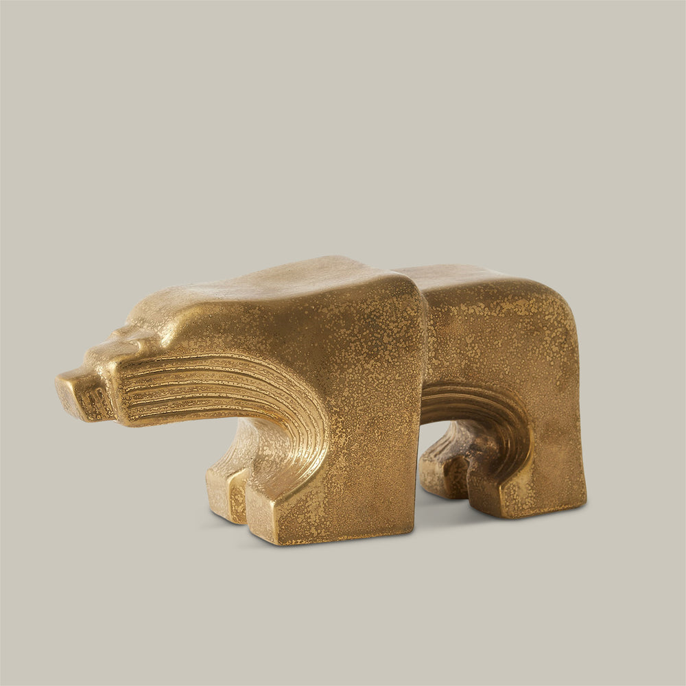 Lemieux et Cie animal object in gold-toned finish, sculptural bear form with textured surface and geometric detailing, shown on neutral studio backdrop.