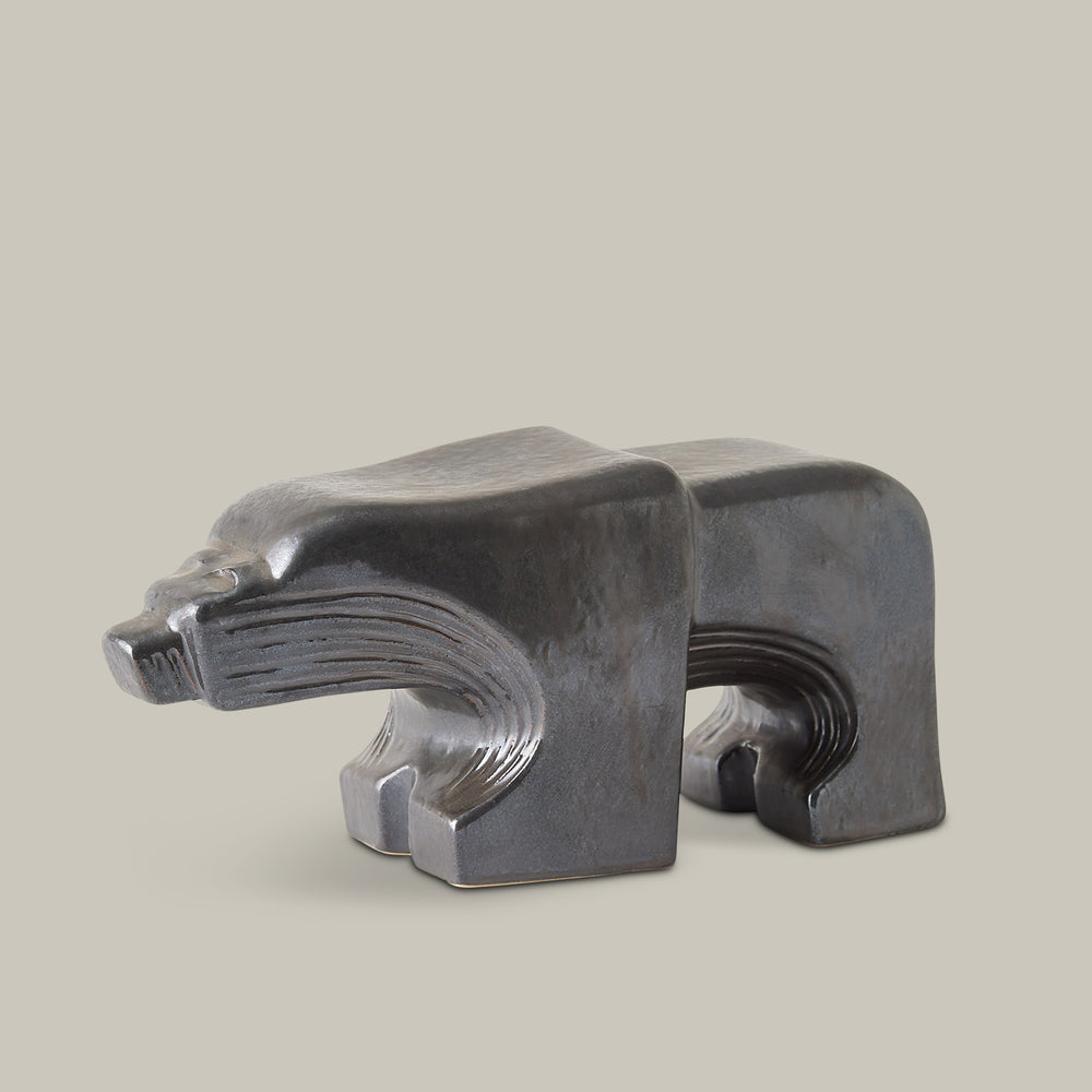 Lemieux et Cie sculptural bison object in dark gray with carved linear details, shown on neutral studio backdrop