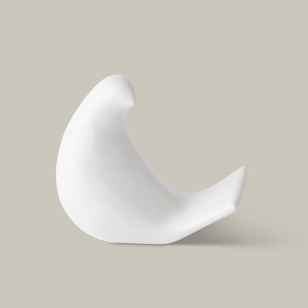 Lemieux et Cie dove object in white, sculptural bird form with curved tail, shown on neutral studio backdrop.