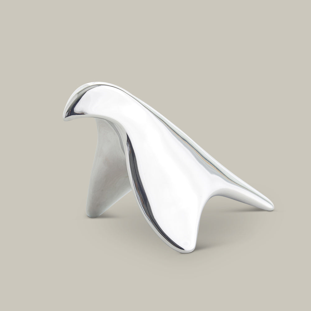 Lemieux et Cie sculptural bird object in polished finish, organic curved form shown on neutral studio backdrop.
