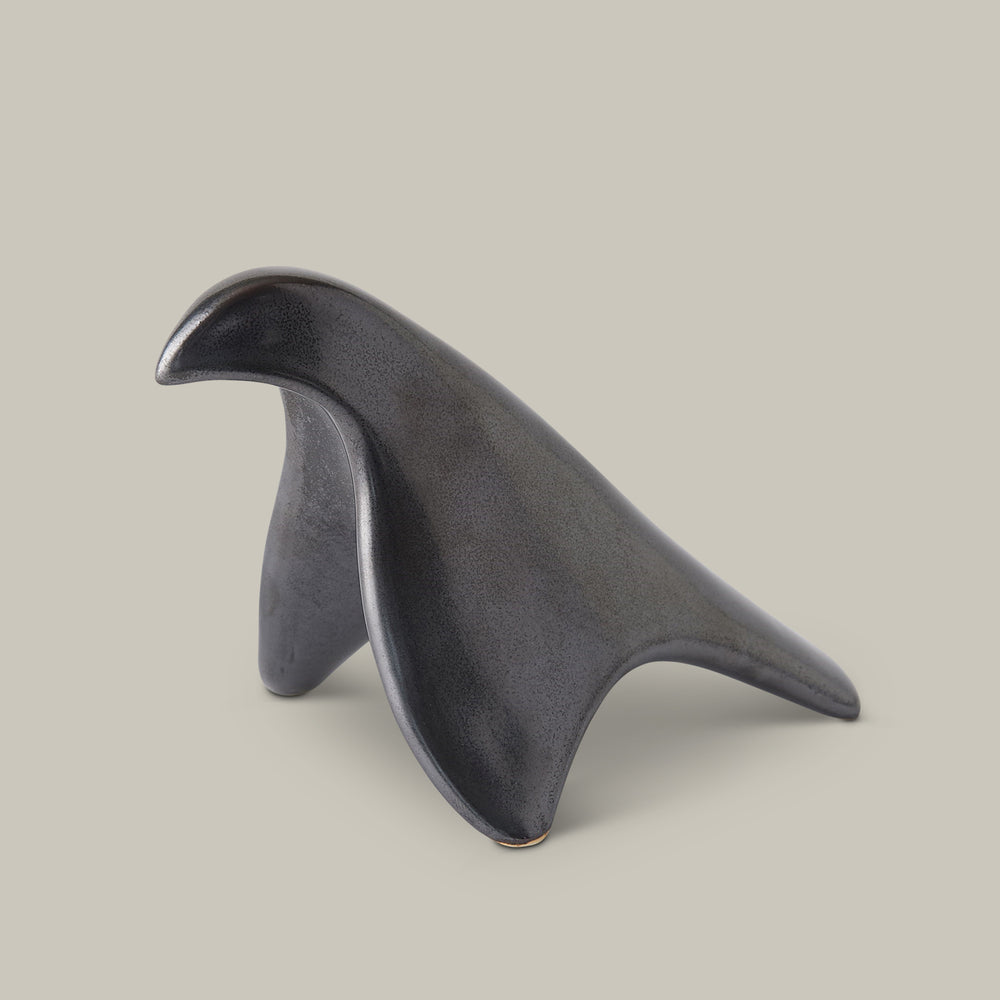 Lemieux et Cie sculptural bird object in dark textured finish, organic curved form shown on neutral studio backdrop.