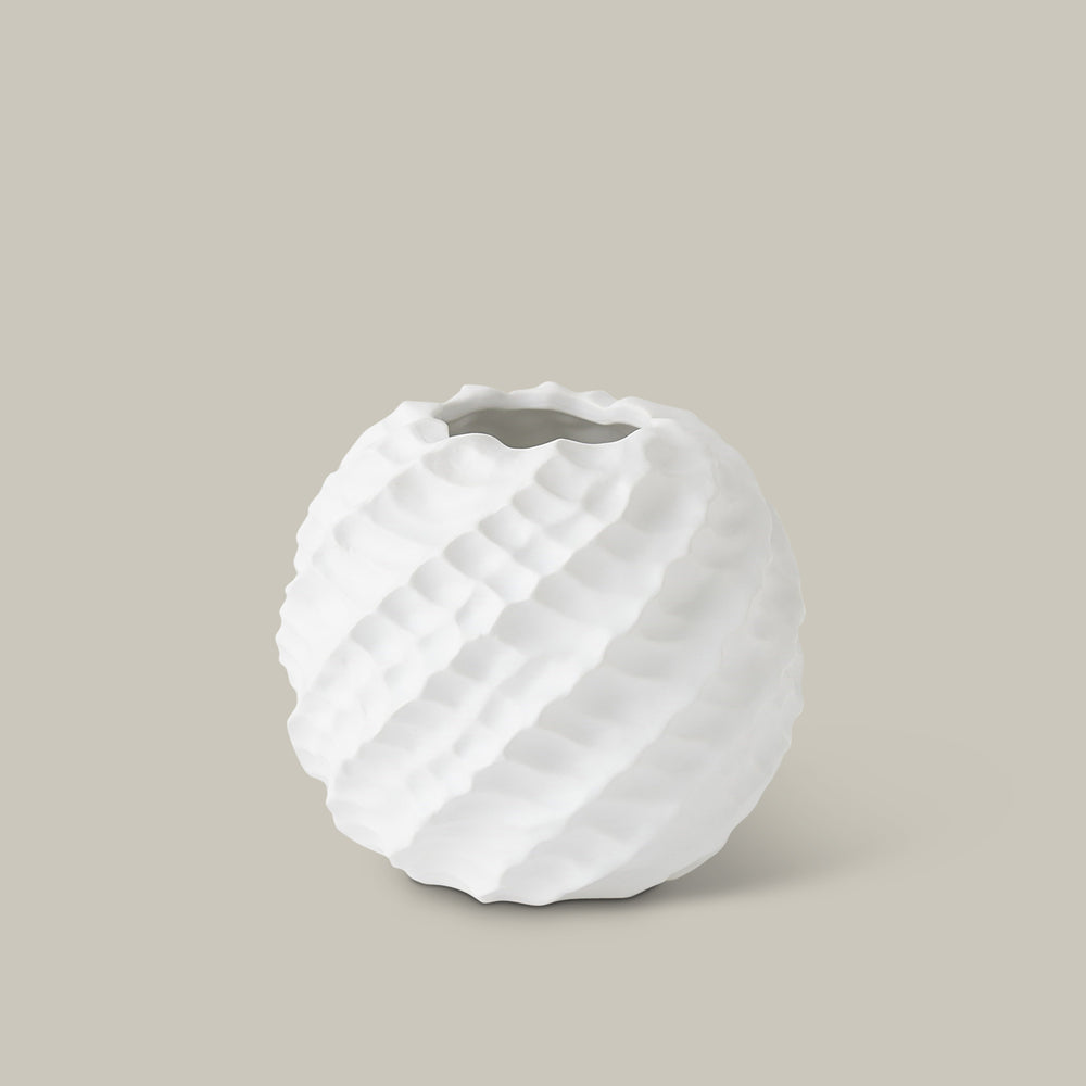 Lemieux et Cie handmade white ceramic vase with sculptural pinched ridges and organic form, shown on neutral studio backdrop.