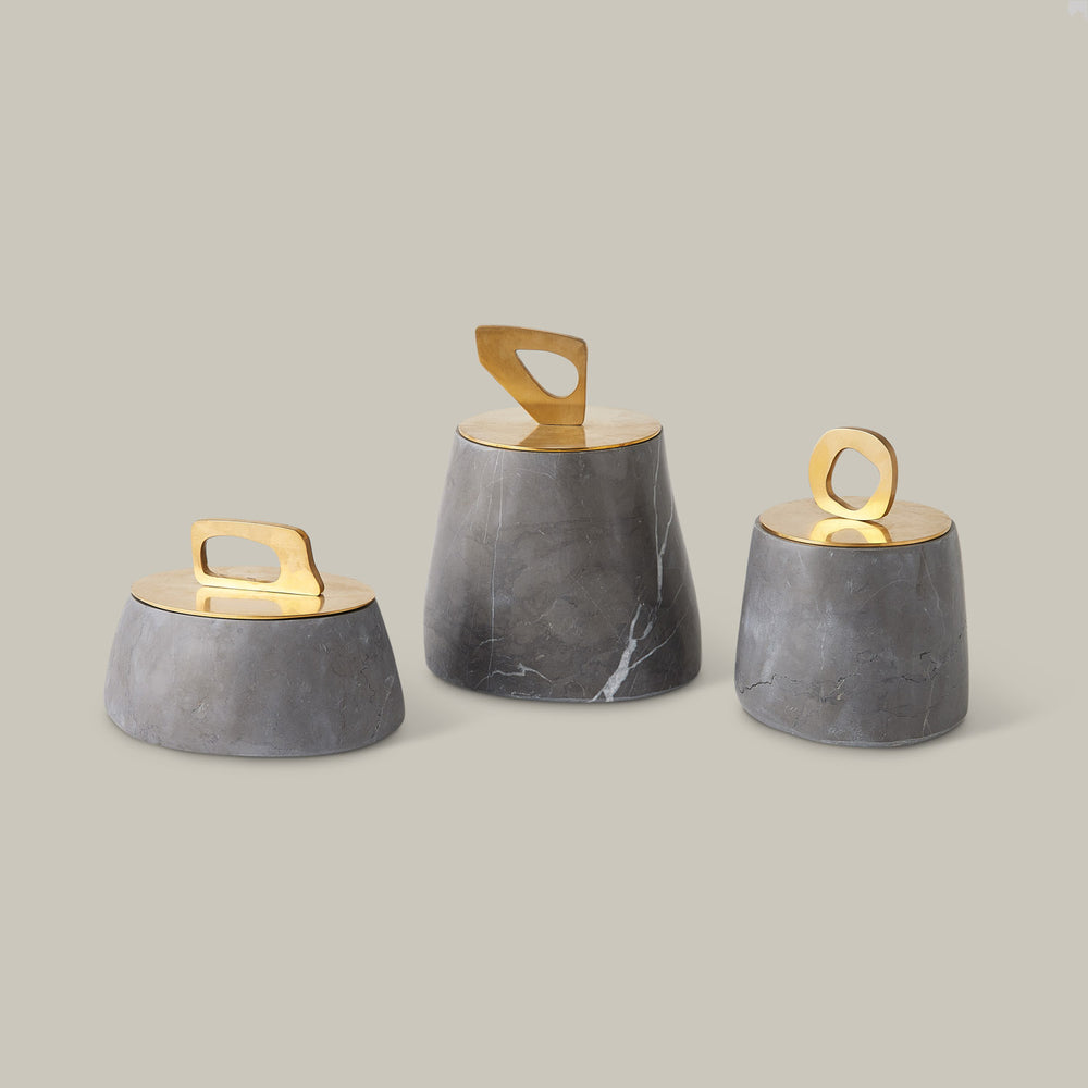 Lemieux et Cie Bocal Lidded Pot in graffito marble with sculptural brass handle, set of three tapered vessels shown on neutral studio backdrop.