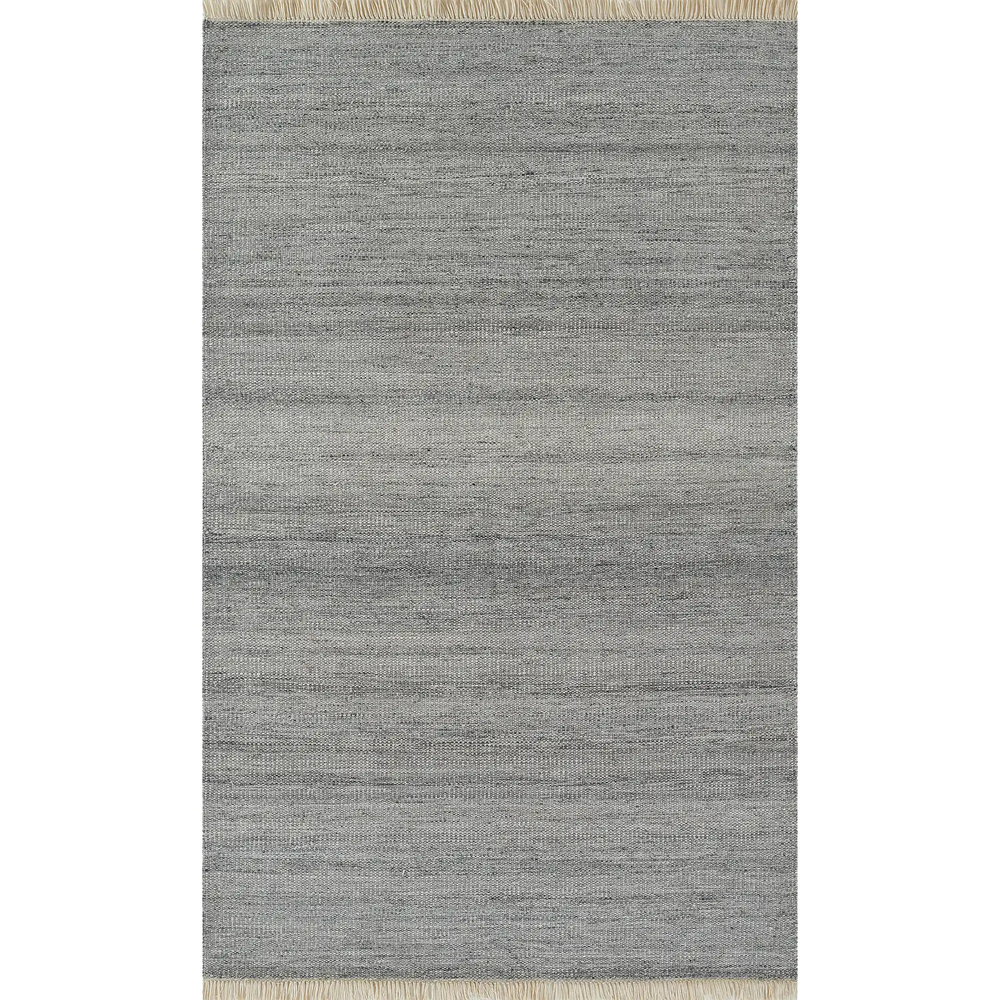 Lemieux et Cie Cove Sofa in grey woven rug, shown on white studio backdrop with neutral fringe detail at edges