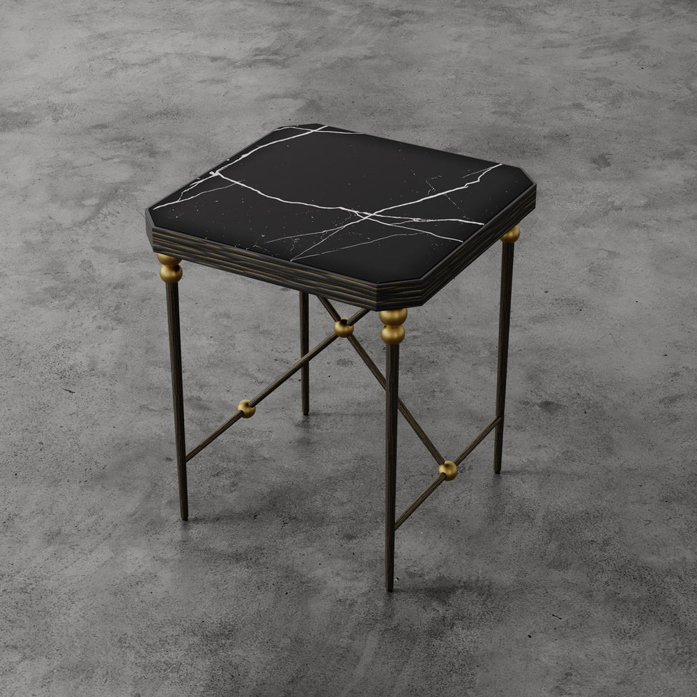 Lemieux et Cie Cambert Square Side Table with honed Nero Marquina marble top and bronze-finished iron frame with brass accents, shown on concrete floor.