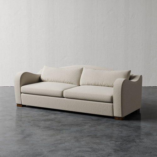 Lemieux Et Cie Elodie Sofa (Made-to-order) Beige sofa on a gray floor with a white wall background