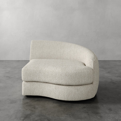 Lemieux Et Cie Rulmann Right Arm Chair Beige armchair on a gray floor with a gray wall background
