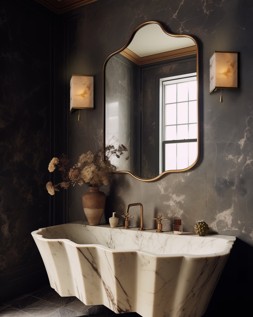 Lemieux et Cie Cleor wall sconce, an Art Deco lighting fixture with a faux alabaster panel framed in burnished brass, casting soft diffused light over a marble sink and decorative mirror in a dark, richly styled bathroom.