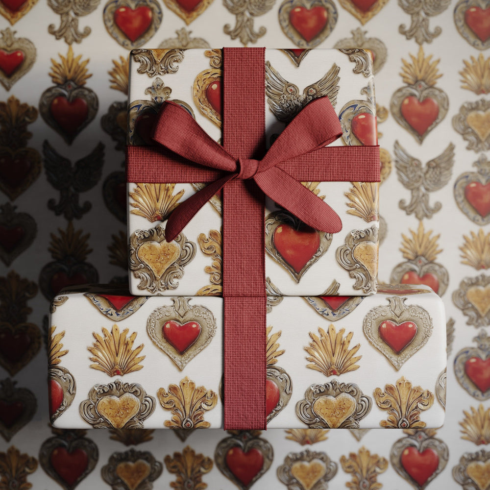 Lemieux et Cie Corazon Sagrado Gift Wrapping Paper with red hearts and gold ornament motif, wrapped gift with deep red ribbon bow.