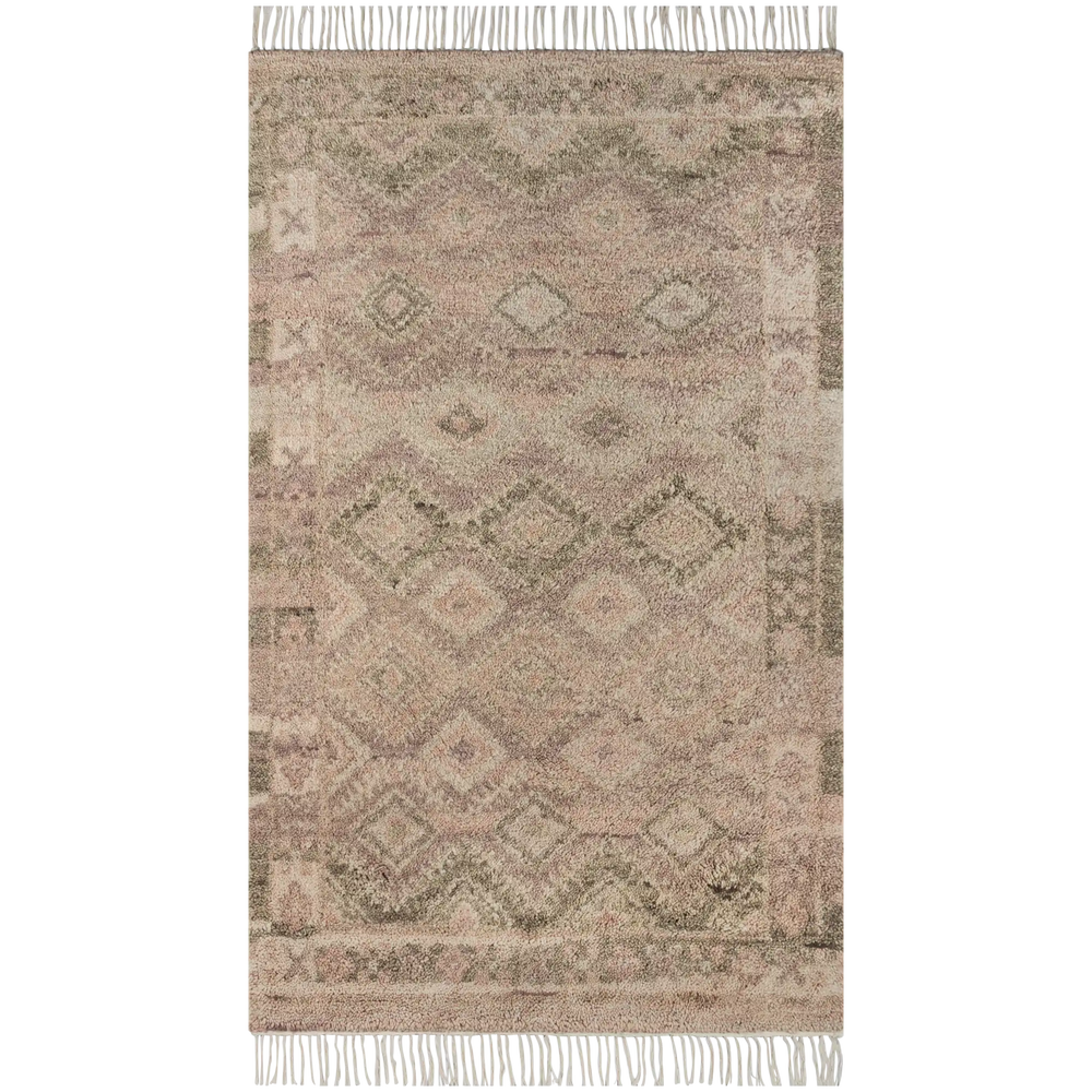 Lemieux et Cie Doukkala rug in dusty mauve wool, hand-knotted rug with geometric Moroccan motifs and white fringe, shown on white studio backdrop.