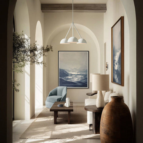 Lemieux et Cie Chandigarh Daybed in teak wood with brown cushion, reclaimed bench in arched plaster-walled sitting room with soft natural light.