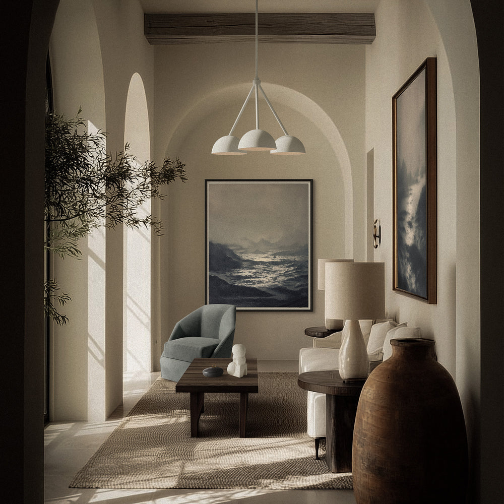 Lemieux et Cie Deauville Limited Edition Art Print, framed seascape artwork hung in arched living room with neutral plaster walls and warm daylight.