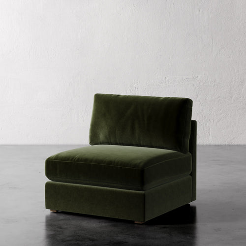 Lemieux Et Cie Chanaux Armless Chair
Green velvet armchair on a dark floor with a light gray textured wall background