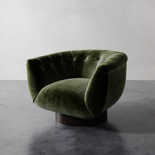 Emerald green Lemieux et Cie Lune Swivel Chair with a rounded tufted back and sculptural form set against a white wall.