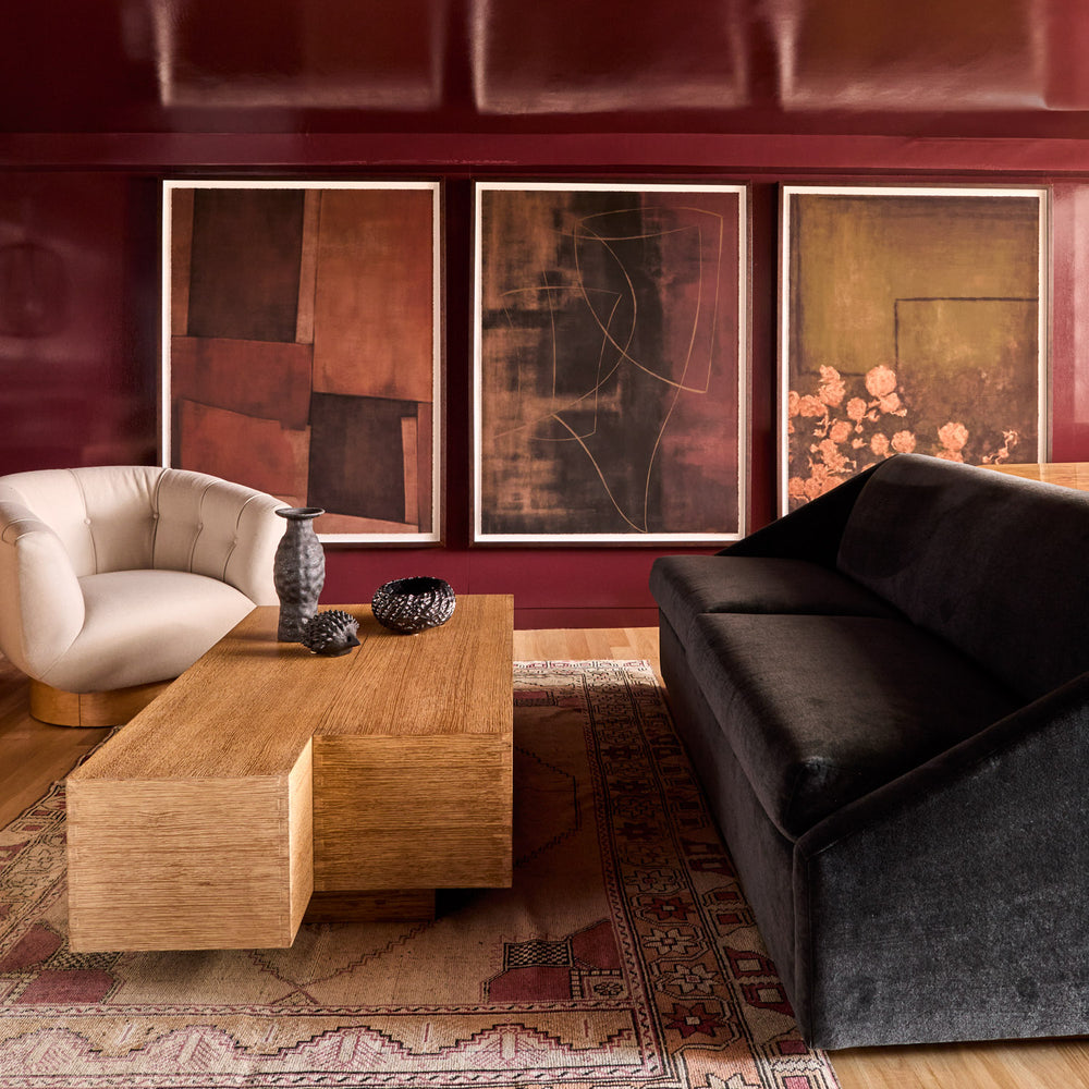 Lemieux et Cie Modern living room with Fontaine Sofa, La Brume Limited Edition Art Print, Le Havre Limited Edition Art Print, Vigne Fleurie Limited Edition Art Print, Lune Swivel Chair and a coffee table.