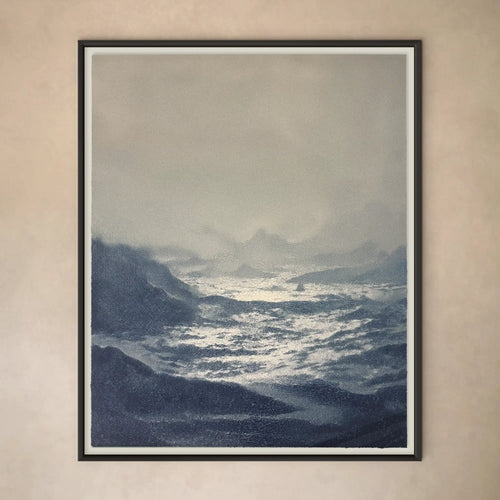 Lemieux et Cie Deauville Limited Edition Art Print depicting stormy seascape in blue and grey tones, framed artwork hung on neutral plaster wall.