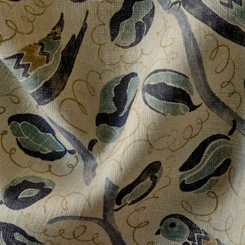 close up of Linen fabric with French bird and botanical pattern in indigo, teal, and hazelnut on natural flax ground
