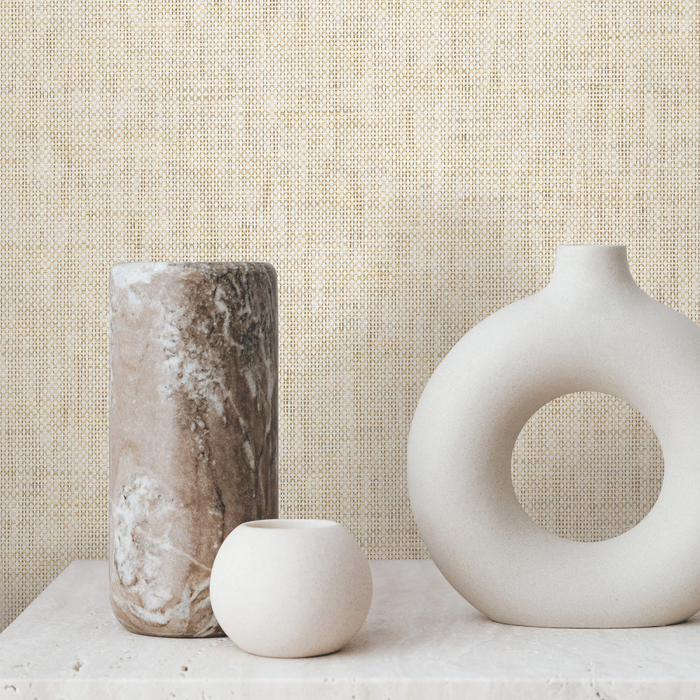 Lemieux et Cie Kami Paperweave in natural beige, handwoven wall covering, shown behind sculptural ceramic vessels on stone surface