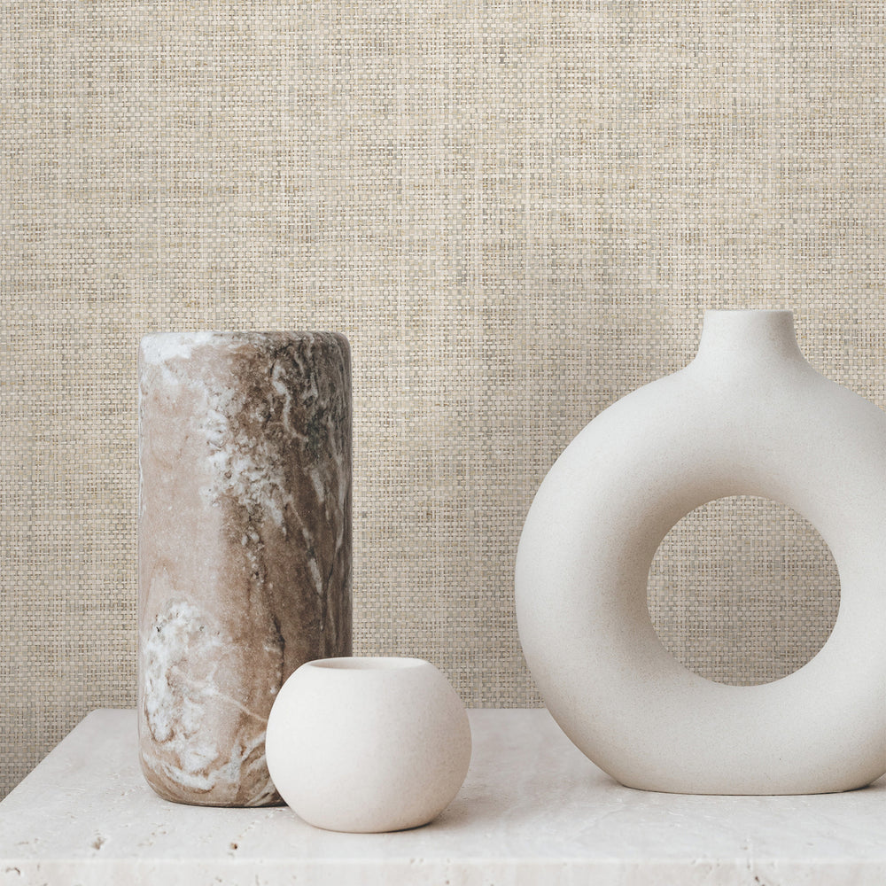 Lemieux et Cie Kami Paperweave in charcoal gray, shown as textured wallcovering behind ceramic vases on stone surface in warm neutral light.