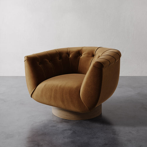 Hazelnut Lemieux et Cie Lune Swivel Chair with a rounded tufted back and sculptural form set against a white wall.
