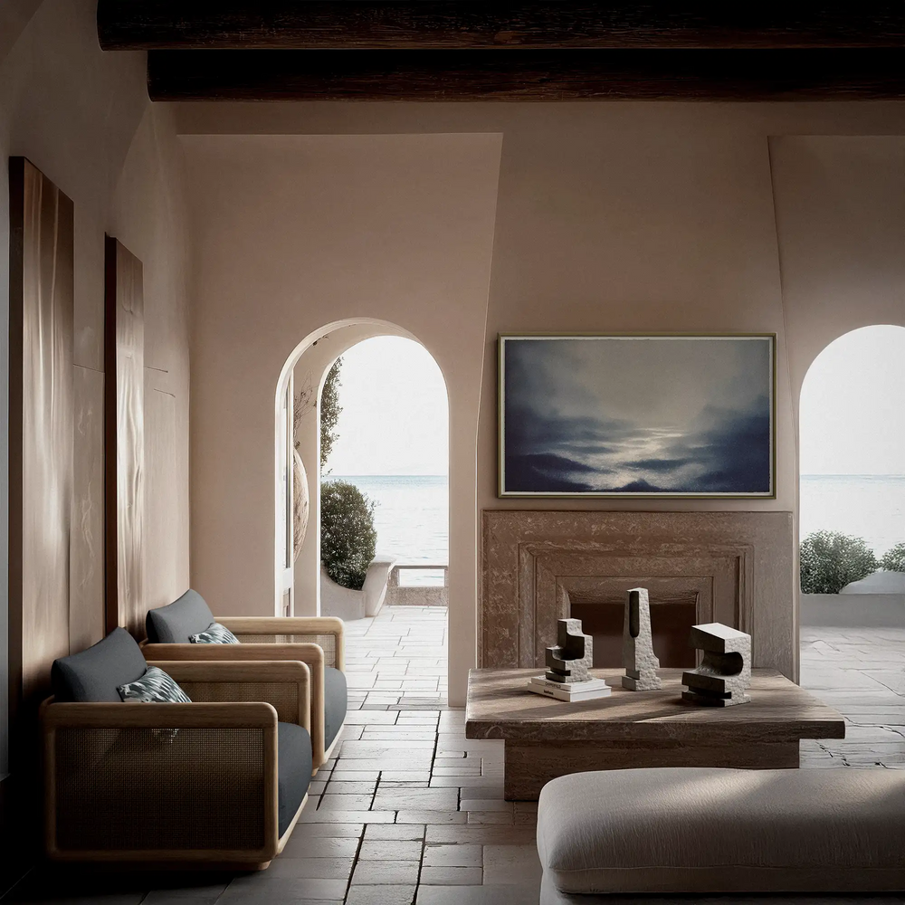 Lemieux et Cie La Structure Sculptures in grey stone, architectural sculptural set displayed on stone fireplace hearth in Mediterranean-style room with arched doorways and neutral plaster walls.