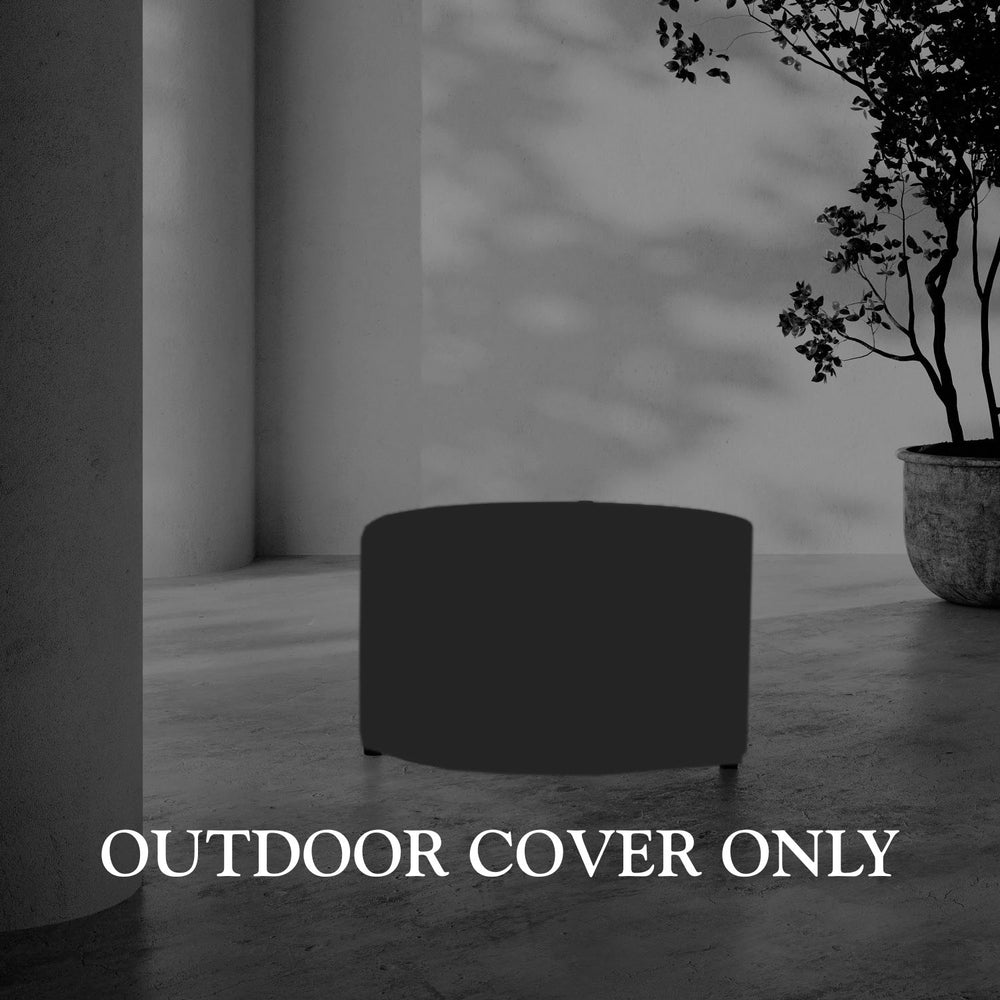 Lemieux et Cie Hudson outdoor cover, round protective cover shown on concrete floor in sheltered courtyard setting with potted tree and plaster walls.