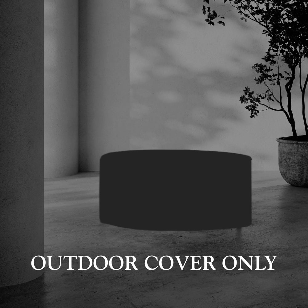 Lemieux et Cie Hudson Round Coffee Table Outdoor Cover in dark charcoal, protective furniture cover shown on concrete floor beside potted tree and white column.
