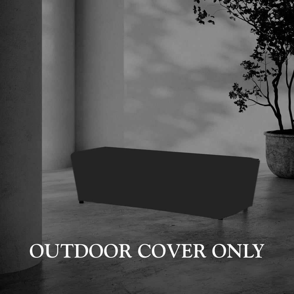 Lemieux et Cie Hudson Rectangular Coffee Table Outdoor Cover, protective furniture cover shown on concrete floor beside white column and potted tree in covered outdoor space.
