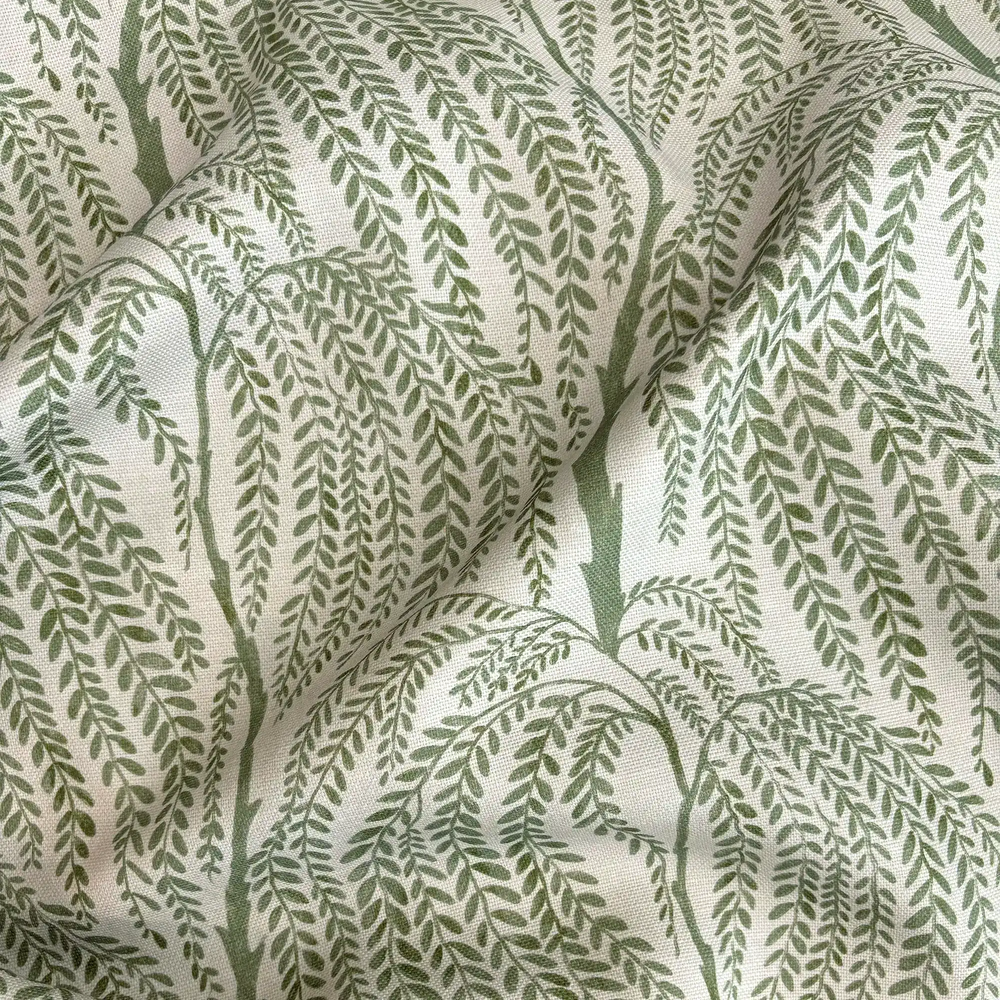 Lemieux et Cie Outdoor Pillow in Willow Trees pattern, textile with botanical willow motif in green on neutral ground, close detail of draped fabric.