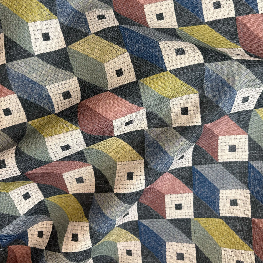 Lemieux et Cie Mosaic Cubes outdoor pillow in charcoal, ivory, coral, citron and blue, geometric pattern with dimensional cube motif, shown draped to reveal woven texture.