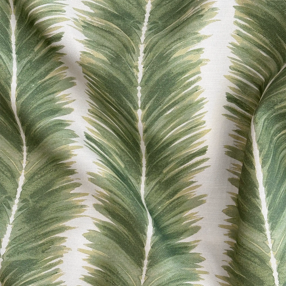 Lemieux et Cie Palm Stripe Outdoor Pillow in green and ivory, close detail of tropical palm leaf pattern on woven textile.