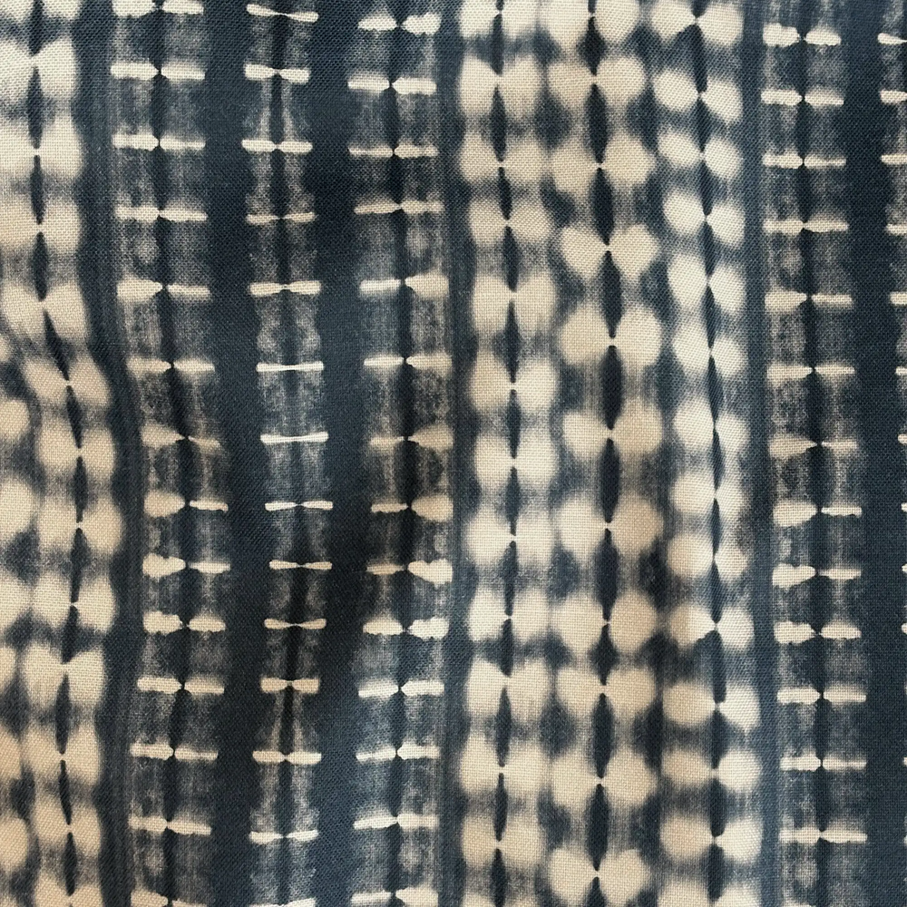 Lemieux et Cie Outdoor Pillow in indigo shibori pattern, textile swatch detail showing hand-dyed geometric resist-dye motifs in ivory and blue tones.