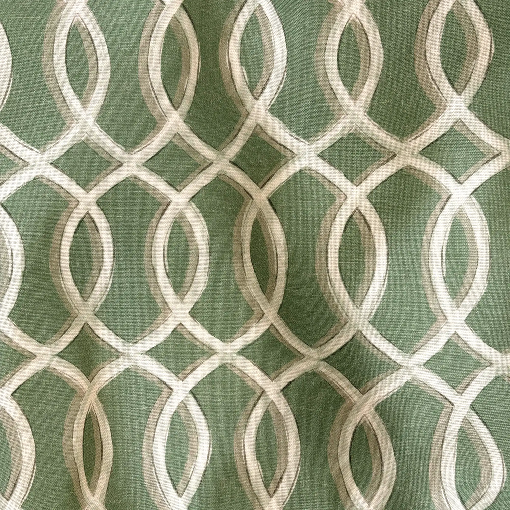 Lemieux et Cie Gatework Green Outdoor Pillow, geometric trellis pattern in sage and cream, close-up detail of woven surface texture.