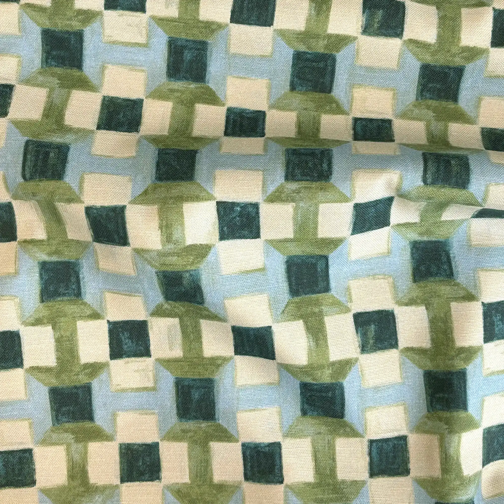 Lemieux et Cie Outdoor Pillow in geometric blue, green and ivory pattern, textile swatch showing woven texture and interlocking square motif.