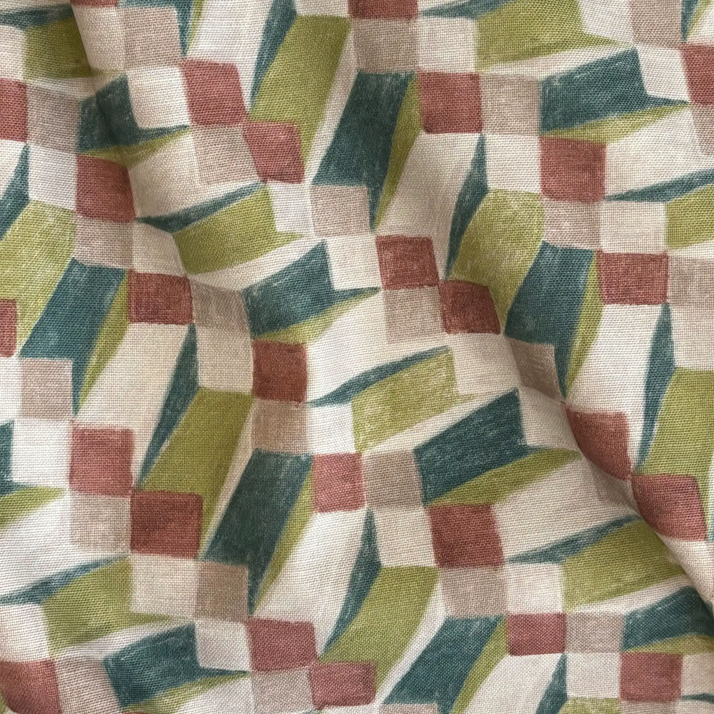 Lemieux et Cie Outdoor Pillow in Op Art Green geometric pattern, textile swatch detail showing teal, terracotta, chartreuse and ivory blocks.