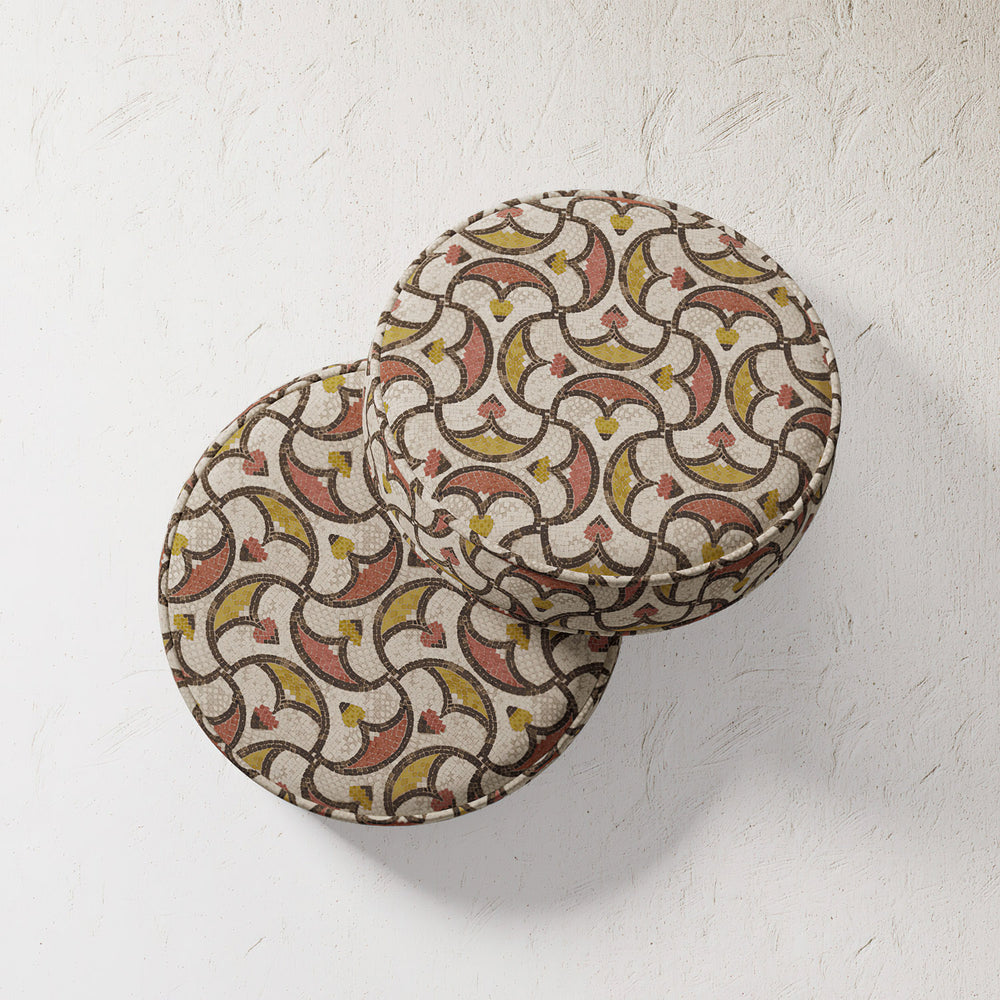 Lemieux et Cie Outdoor Pillow in Algerian Mosaic pattern with geometric arches in coral, chartreuse and ivory, round cushions on textured plaster wall.