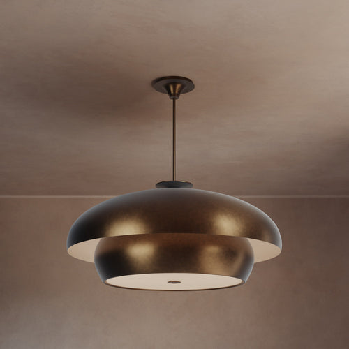 Lemieux et Cie Solene Chandelier, sculptural tiered dome pendant with warm patinated finish, suspended in a neutral plaster-walled interior with soft ambient light.