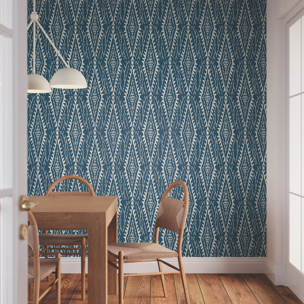 Lemieux et Cie Rousseau Paperweave in sage green with tan brown, diamond tapestry weave wallcovering, dining room with wood table, woven chairs, and white pendant light on wood floors.