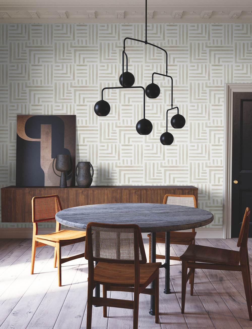 Lemieux et Cie Painterly Labyrinth wallpaper in soft beige geometric pattern, shown in a dining room with wood floors and geometric coffered ceiling.