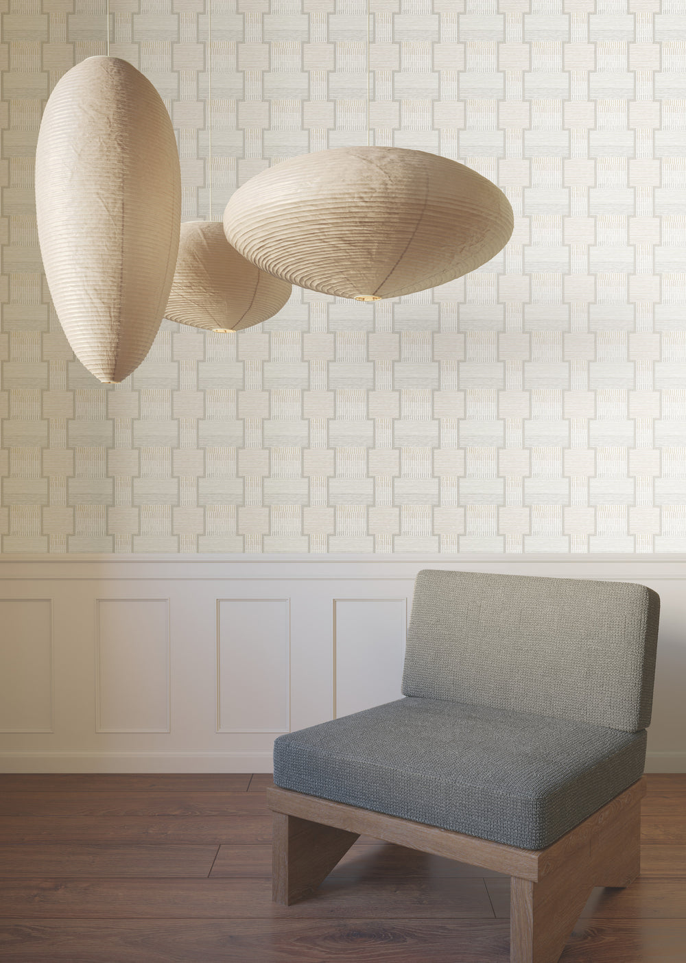 Lemieux et Cie Camelia Blossom wallcovering in charcoal gray and almond cream, sculptural pendant lights hung above neutral paneled walls and wood floors.