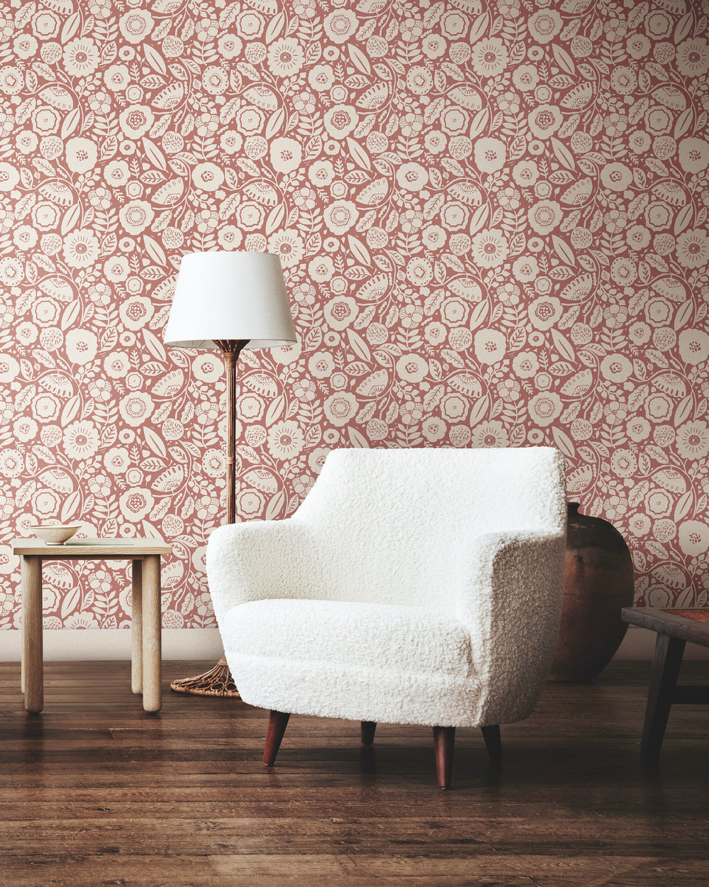 Lemieux et Cie Tachette wallpaper in terracotta on alabaster white, floral brushstroke pattern, styled with white bouclé chair and table lamp on wood floors.