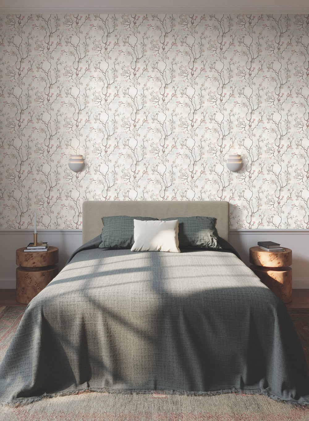 Lemieux et Cie Avril Chinoiserie wallpaper in peacock blue on misty gray, bedroom with upholstered bed, burl nightstands, layered textiles, warm light.
